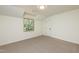 Bedroom featuring plush carpeting, a window, and a closet door at 1604 Westbridge Ct, Raleigh, NC 27606