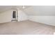 Neutral bonus room features a ceiling fan, carpet, and access to multiple closets and attic spaces at 1604 Westbridge Ct, Raleigh, NC 27606