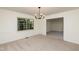 Dining room with a modern light fixture and bright natural light from windows at 1604 Westbridge Ct, Raleigh, NC 27606