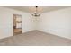 Bright dining room with modern chandelier and pass-through to the kitchen at 1604 Westbridge Ct, Raleigh, NC 27606