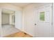 Bright entryway with hardwood floors, leading to a carpeted living area through a wide doorway at 1604 Westbridge Ct, Raleigh, NC 27606