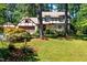 Beautiful Tudor style house with manicured lawn and mature trees for plenty of shade at 1604 Westbridge Ct, Raleigh, NC 27606