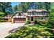 Charming two-story home with brick and Tudor-style accents, an attached garage, and well-manicured landscaping at 1604 Westbridge Ct, Raleigh, NC 27606