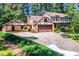 Charming two-story home with brick and Tudor-style accents, a covered carport, and a large driveway at 1604 Westbridge Ct, Raleigh, NC 27606