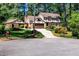 Charming Tudor-style home featuring a two-car garage, a porte-cochère, and a lush front lawn at 1604 Westbridge Ct, Raleigh, NC 27606