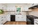 Bright kitchen with white cabinets, black appliances, light countertops, wood floors and natural light from the window at 1604 Westbridge Ct, Raleigh, NC 27606