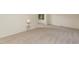 Bright living room featuring neutral carpet, with views into the adjacent room at 1604 Westbridge Ct, Raleigh, NC 27606