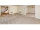 Open living room with neutral walls and carpet and staircase access at 1604 Westbridge Ct, Raleigh, NC 27606