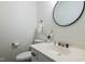 Powder room featuring a stylish mirror and a classic white sink at 1604 Westbridge Ct, Raleigh, NC 27606