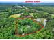 An aerial view of the expansive wooded property near Jordan Lake at 168 E Deer, Apex, NC 27523