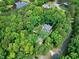 Aerial view of property nestled among mature trees, showcasing the roof and surrounding landscape at 168 E Deer, Apex, NC 27523