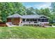 Expansive backyard featuring a brick home with a screened porch, spacious deck and a relaxing hot tub at 168 E Deer, Apex, NC 27523