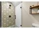 Modern bathroom featuring a glass-enclosed shower with decorative tile and sleek fixtures at 168 E Deer, Apex, NC 27523