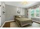 This cozy bedroom has wood floors, a comfortable bed and lots of natural light at 168 E Deer, Apex, NC 27523