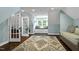 Bright bedroom with a built-in window seat, hardwood flooring, and a decorative rug at 168 E Deer, Apex, NC 27523