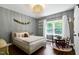 Charming bedroom featuring a whimsical chandelier, decorative garland, and natural light at 168 E Deer, Apex, NC 27523