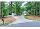 Beautiful brick home with a long driveway surrounded by lush trees and landscaping at 168 E Deer, Apex, NC 27523