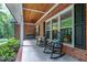 Inviting front porch featuring rocking chairs, porch swing and stylish wood planked ceiling at 168 E Deer, Apex, NC 27523
