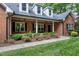 Inviting front porch with rocking chairs and lush landscaping at 168 E Deer, Apex, NC 27523