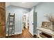 Light and airy hallway with views into other rooms, wooden floors and decor at 168 E Deer, Apex, NC 27523