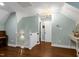 Upstairs hallway featuring a staircase, a light-filled door, and light green walls at 168 E Deer, Apex, NC 27523