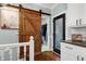 Hallway with wooden barn door leading to laundry room and access to exterior at 168 E Deer, Apex, NC 27523