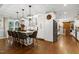 Eat in kitchen with designer lighting and island with barstool seating at 168 E Deer, Apex, NC 27523