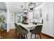 Bright eat-in kitchen with marble island, pendant lighting, hardwood floors, and white cabinets at 168 E Deer, Apex, NC 27523