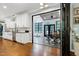 Modern, white kitchen features stainless steel appliances and opens to a sunroom at 168 E Deer, Apex, NC 27523