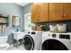 Convenient laundry room with washer, dryer, utility sink, and storage at 168 E Deer, Apex, NC 27523
