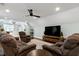 Spacious living room area offering comfortable seating, a ceiling fan, and a large flat-screen TV at 168 E Deer, Apex, NC 27523