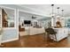 Open-concept living space with hardwood floors, island seating, and comfortable furnishings at 168 E Deer, Apex, NC 27523