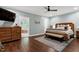 Comfortable bedroom featuring a king bed, wood furnishings, and access to the bathroom at 168 E Deer, Apex, NC 27523