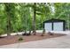 Spacious outbuilding features two garage doors and is surrounded by landscaping at 168 E Deer, Apex, NC 27523