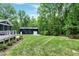 A Large outbuilding in backyard surrounded by lush greenery and manicured lawn at 168 E Deer, Apex, NC 27523