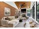 Inviting sunroom featuring a stone fireplace, wood ceiling and brick wall at 168 E Deer, Apex, NC 27523