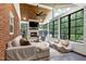 Bright sunroom with stone fireplace, wood ceiling, and many windows overlooking the greenery at 168 E Deer, Apex, NC 27523