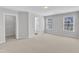 A bedroom with an ensuite, lots of light and neutral carpeting that provides a blank canvas for the imagination at 172 Wellons Creek Dr, Garner, NC 27529
