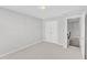 Well-lit neutral bedroom with a double closet and stairs to another level at 172 Wellons Creek Dr, Garner, NC 27529