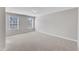 A bright bedroom features neutral carpeting and multiple windows, offering a serene and comfortable space at 172 Wellons Creek Dr, Garner, NC 27529