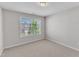 Well-lit bedroom with a large window overlooking green space at 172 Wellons Creek Dr, Garner, NC 27529