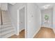 Hallway with an entry and a view of the backyard with steps to the second level on the left at 172 Wellons Creek Dr, Garner, NC 27529