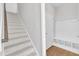 Hallway with entry to the home from the garage and stairs to the upper level, features an organization station at 172 Wellons Creek Dr, Garner, NC 27529