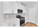 Kitchen area showcases white cabinets, stainless steel appliances, and gas range at 172 Wellons Creek Dr, Garner, NC 27529