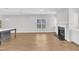 Open-concept living room features a fireplace, lots of natural light, and hard surface floors throughout at 172 Wellons Creek Dr, Garner, NC 27529