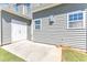 Enclosed patio featuring a large concrete surface, a garage, and light gray vinyl siding at 172 Wellons Creek Dr, Garner, NC 27529