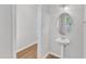 Powder room features a pedestal sink, an oval mirror, and views to the exterior through a window at 172 Wellons Creek Dr, Garner, NC 27529