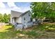 Backyard featuring a spacious deck with lush greenery, and a well-maintained yard, great for outdoor living at 1732 Bobwhite Ln, Rocky Mount, NC 27804