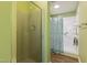 A clean, bright bathroom features a glass enclosed shower and tub with a shower curtain for added convenience at 1732 Bobwhite Ln, Rocky Mount, NC 27804