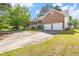 Wide driveway and brick home with front porch, perfect for comfortable living and easy access at 1732 Bobwhite Ln, Rocky Mount, NC 27804